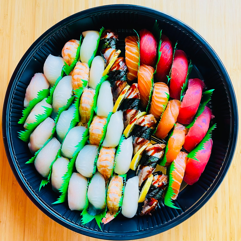 A large platter of Awi Sushi nigiri, including tuna, salmon, shrimp, and white fish.